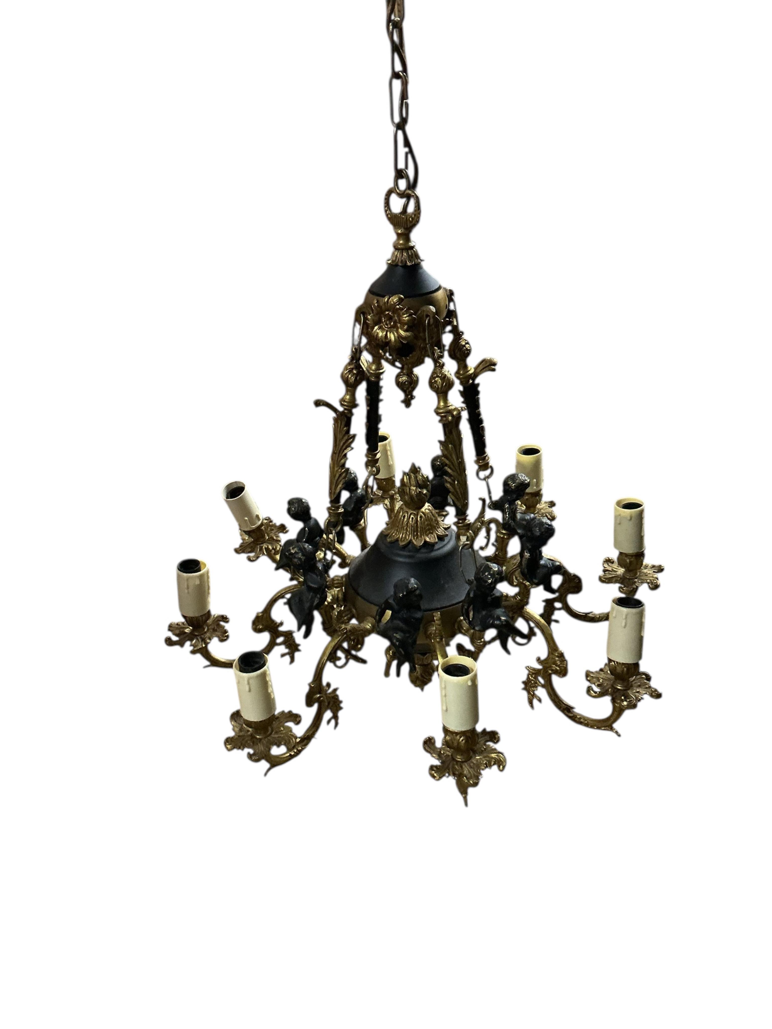 An eight branch gilt metal electrolier, cast with cherubs, width 60cm